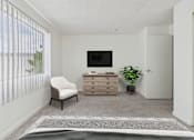 Thumbnail 6 of 45 - A room with a chair, a cabinet, and a television.