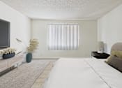 Thumbnail 8 of 45 - A bedroom with a large bed and a television on the wall.