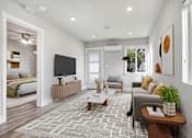 Thumbnail 4 of 10 - a living room with a couch and a tv
