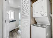 Thumbnail 7 of 10 - a white laundry room with a washer and dryer in it