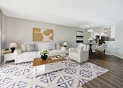 Thumbnail 2 of 41 - A living room with a white couch, a coffee table, and a painting on the wall.