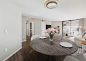Thumbnail 4 of 41 - A dining room with a round table and chairs.