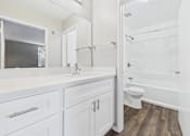 Thumbnail 7 of 41 - A white bathroom with a toilet, sink, and bathtub.