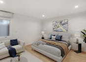 Thumbnail 19 of 45 - A bedroom with a bed, a couch, and a painting on the wall.