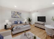 Thumbnail 21 of 45 - A modern bedroom with a large bed and a television in the corner.
