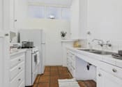 Thumbnail 17 of 61 - A small white kitchen with a tiled floor.