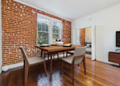 Thumbnail 18 of 61 - A dining room with a wooden table and chairs.