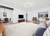 Thumbnail 14 of 61 - A living room with a large bed in the foreground.