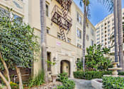 Thumbnail 60 of 61 - A building with a balcony and a fountain in front of it.