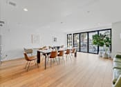Thumbnail 29 of 119 - A modern dining room with a wooden table and chairs.