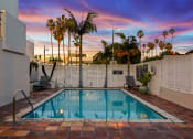 Thumbnail 23 of 66 - the pool of a hotel with palm trees and a colorful sky