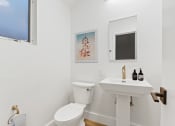 Thumbnail 10 of 66 - a bathroom with a toilet and a sink and a window