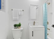 Thumbnail 11 of 66 - a bathroom with a toilet and a sink and a shower