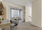 Thumbnail 6 of 66 - a living room with a couch and a chair and a sliding glass door