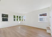 Thumbnail 4 of 20 - A room with a white wall and a window with a view of a snowy landscape.