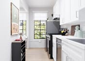 Thumbnail 19 of 25 - Luxury apartment kitchen with premium stainless steel appliances and modern finishes.
