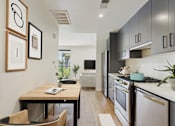 Thumbnail 25 of 157 - A modern kitchen with a table and chairs.