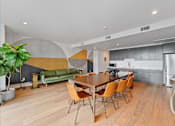 Thumbnail 28 of 119 - A modern dining room with a wooden table and chairs.