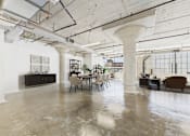 Thumbnail 7 of 123 - A large open space with a concrete floor and exposed ceiling beams.