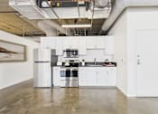 Thumbnail 1 of 123 - A modern kitchen with white cabinets and stainless steel appliances.