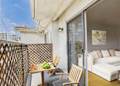 Thumbnail 5 of 19 - A patio with a table and chairs is shown.