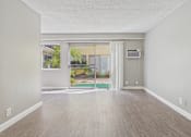 Thumbnail 39 of 51 - A room with a sliding glass door leading to a patio.