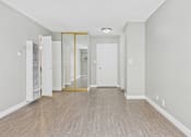Thumbnail 44 of 51 - A room with a white door and a white wall.