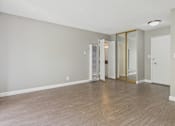 Thumbnail 42 of 51 - A room with a wooden floor and a white ceiling.