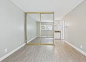 Thumbnail 46 of 51 - A room with a wooden floor and a glass door.