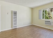 Thumbnail 29 of 51 - A room with a window and a wall-mounted air conditioner unit.