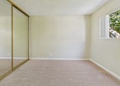 Thumbnail 30 of 51 - A room with a carpeted floor and a sliding glass door.