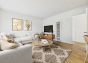 Thumbnail 5 of 65 - A living room with a white couch and a coffee table.