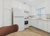 Thumbnail 1 of 65 - A kitchen with white cabinets and a refrigerator.