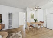 Thumbnail 3 of 65 - A dining room with a table set for two and a ceiling fan.