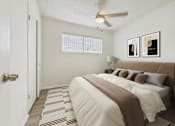 Thumbnail 8 of 65 - A bedroom with a bed, pillows, and a ceiling fan.
