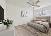 Thumbnail 6 of 65 - A bedroom with a large bed, a ceiling fan, and a plant on a dresser.