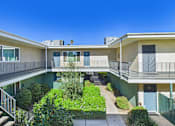 Thumbnail 16 of 65 - A sunny day at a residential complex with a clear blue sky.