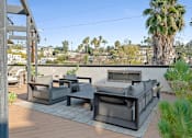 Thumbnail 18 of 119 - A patio with a couch, chairs and a table.