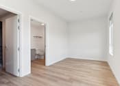 Thumbnail 145 of 163 - A room with a wooden floor and white walls.