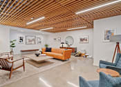 Thumbnail 21 of 119 - A living room with a wooden ceiling and furniture.