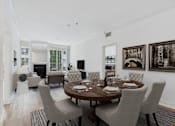 Thumbnail 3 of 16 - A dining room with a table set for six.