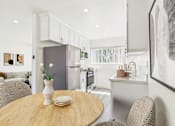 Thumbnail 21 of 41 - A modern kitchen with a wooden table and chairs.
