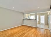 Thumbnail 14 of 24 - the living room and kitchen of an empty house with wood floors