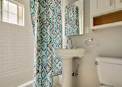 Thumbnail 20 of 24 - a bathroom with a sink and a shower curtain