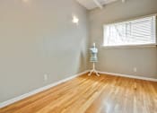 Thumbnail 18 of 24 - a room with a dresser and a window and wood floors