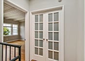 Thumbnail 17 of 24 - the entryway of a house with white doors and a staircase