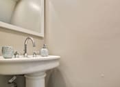 Thumbnail 19 of 24 - a small bathroom with a sink and a mirror