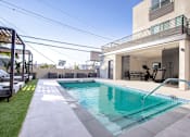 Thumbnail 21 of 31 - a swimming pool in the backyard of a house