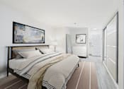 Thumbnail 17 of 127 - A bedroom with a large bed and a painting on the wall.