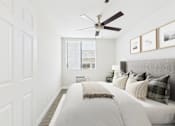 Thumbnail 55 of 127 - A bedroom with a bed, pillows, and pictures on the wall.